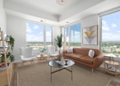 Thumbnail 4 of 83 - a living room with a brown couch and three windows