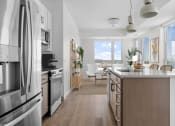 Thumbnail 2 of 83 - an open kitchen and living room with a view of a dining room and a table