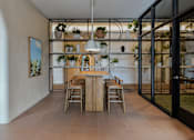 Thumbnail 65 of 83 - A dining room with a wooden table and chairs.