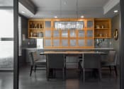 Thumbnail 27 of 30 - a dining room with a table and chairs and a kitchen at Park 205, Park Ridge, IL, 60068