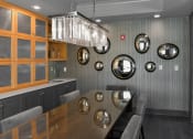 Thumbnail 28 of 30 - a dining room with a table and chairs and several mirrors on the wall at Park 205, Park Ridge, Illinois