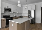 Thumbnail 29 of 83 - Modern island style kitchen at The Hallon II luxury apartments in Hopkins, MN