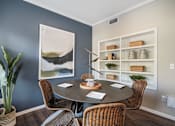 Thumbnail 4 of 19 - A dining room with a round table and chairs.
