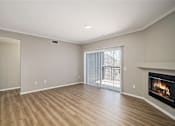 Thumbnail 17 of 19 - A room with a fireplace and a sliding glass door.