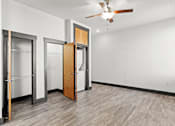 Thumbnail 9 of 21 - A room with a ceiling fan and a door.