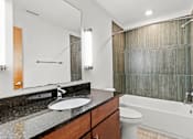 Thumbnail 13 of 21 - A bathroom with a sink, toilet, and bathtub.