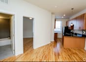 Thumbnail 16 of 21 - A room with wooden floors and white walls.