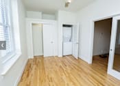 Thumbnail 21 of 21 - A room with wooden floors and white walls.