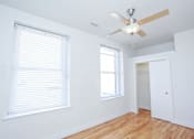 Thumbnail 8 of 21 - A room with a ceiling fan and a window with blinds.