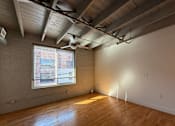 Thumbnail 5 of 10 - A room with wooden floors and a window with blinds.