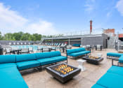Thumbnail 2 of 17 - Image of fire pit surrounded by blue sofas