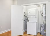 Thumbnail 9 of 9 - a small laundry room with a washer and dryer in it and a door
