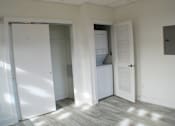 Thumbnail 5 of 5 - A room with a white door and a white refrigerator.