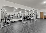 Thumbnail 20 of 21 - A spacious gym with a variety of equipment.