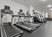 Thumbnail 19 of 21 - A row of treadmills in a gym.