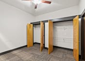 Thumbnail 15 of 21 - A room with a carpeted floor and a ceiling fan.