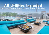 Thumbnail 1 of 17 - Image of firepit surrounded by blue sofas with the text "All Utilities Included - Internet, Electric, Water, Sewer, Trash & Parking"