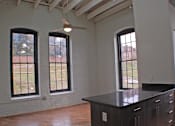 Thumbnail 5 of 5 - A room with a large island and three windows.