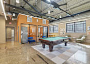 Thumbnail 7 of 22 - A billiard table is in the middle of a room with a pool table chair and a pool table table.