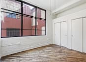 Thumbnail 17 of 22 - A room with a red wall outside the window and white walls inside.