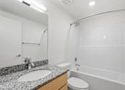 Thumbnail 22 of 22 - A bathroom with a sink, toilet, and bathtub.