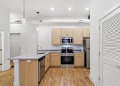 Thumbnail 13 of 22 - A kitchen with wooden cabinets and a granite countertop.