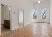 Thumbnail 4 of 9 - Large living room space facing Broad Street in Richmond, Virginia. Warm hardwood floors and bright white walls