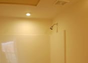 Thumbnail 2 of 6 - A white toilet is in a bathroom with a walk-in shower.