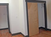 Thumbnail 4 of 6 - A room with a ceiling fan and a doorway covered in cardboard.