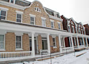 Thumbnail 1 of 22 - A row of Victorian style houses with snow on the ground.