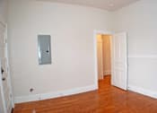 Thumbnail 10 of 22 - A room with a white door and a mirror on the wall.