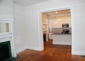 Thumbnail 8 of 22 - A kitchen is visible through an open doorway.