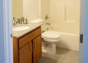 Thumbnail 12 of 22 - A white toilet sits next to a sink in a bathroom.