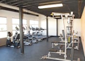 Thumbnail 19 of 19 - A gym with a variety of equipment including a leg press machine.