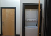 Thumbnail 4 of 6 - A small white washing machine is in a doorway.