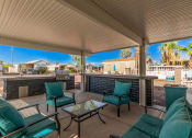 Thumbnail 9 of 26 - a covered patio with green chairs and a fire pit