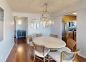 Thumbnail 9 of 43 - A dining room with a white table and chairs at 10 West Apartments, New York