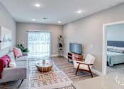 Thumbnail 6 of 23 - Living room with patio view at Westown at Wilson, Grand Rapids, Michigan