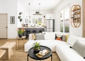Thumbnail 13 of 33 - a living room with a white couch and a kitchen in the background at Onyx at Westgate Apartments, Arizona, 85305