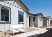 Thumbnail 20 of 33 - a bench in front of a row of houses at Onyx at Westgate Apartments, Arizona