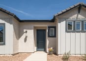 Thumbnail 19 of 33 - the front of a white house with a blue door at Onyx at Westgate Apartments, Glendale