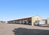 Thumbnail 4 of 15 - a large building with trucks parked outside of it