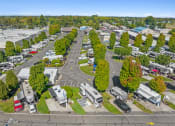 Thumbnail 3 of 15 - an aerial view of a parking lot with rvs and trees