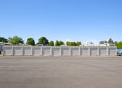 Thumbnail 5 of 15 - an empty parking lot with a white fence