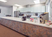 Thumbnail 9 of 15 - a kitchen with stainless steel appliances and a counter with a washing machine