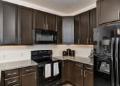 Thumbnail 3 of 34 - Kitchen With Black Appliances at West Line Flats Apartments in Lakewood, CO