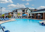 Thumbnail 25 of 37 - our apartments offer a large swimming pool with chairs and umbrellas at Annandale Apartment Homes, Murfreesboro, TN