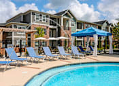 Thumbnail 26 of 37 - our apartments offer a swimming pool with chairs and umbrellas at Annandale Apartment Homes, Murfreesboro, 37128