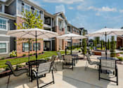 Thumbnail 30 of 37 - our apartments feature a patio with tables and chairs and umbrellas at Annandale Apartment Homes, Murfreesboro, Tennessee