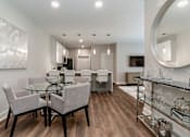 Thumbnail 5 of 37 - a living room and dining room with a glass table and chairs at Annandale Apartment Homes, Murfreesboro
